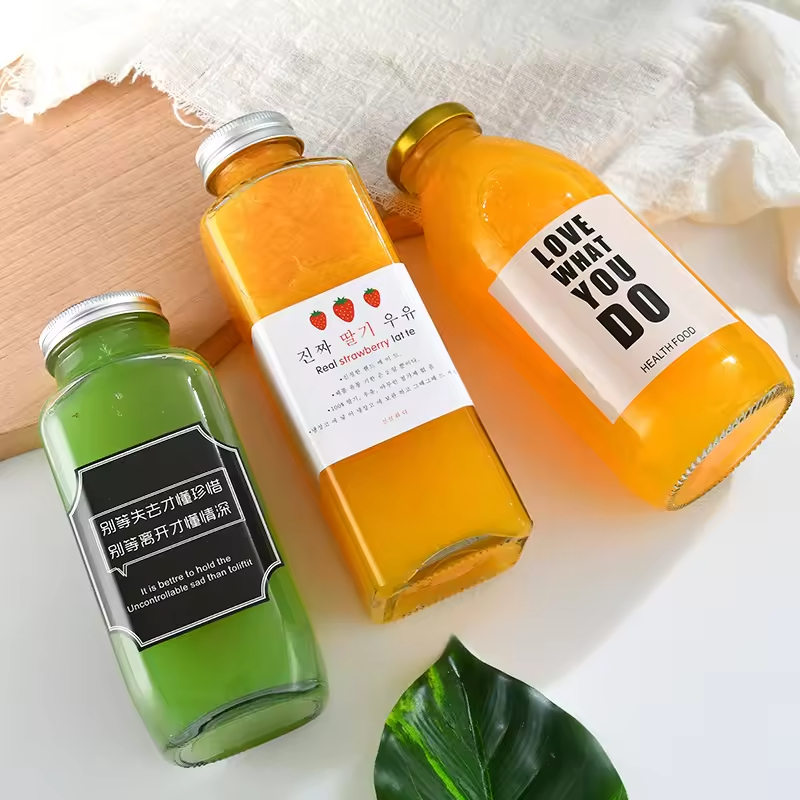 Photograph of real glass juice/beverage bottles with lids from BC Glass